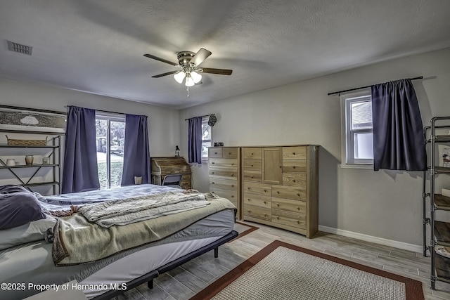 bedroom with a textured ceiling and ceiling fan