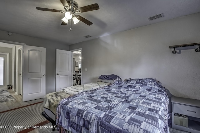 bedroom featuring a textured ceiling and ceiling fan