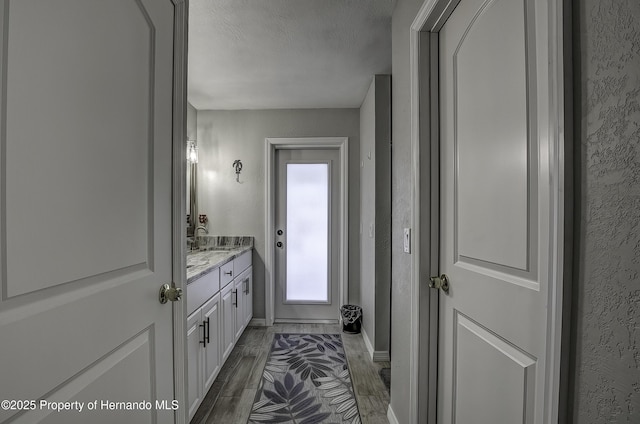 bathroom with a textured ceiling and vanity