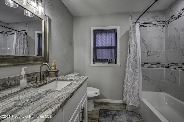 full bathroom with toilet, vanity, a textured ceiling, and shower / bath combination with curtain