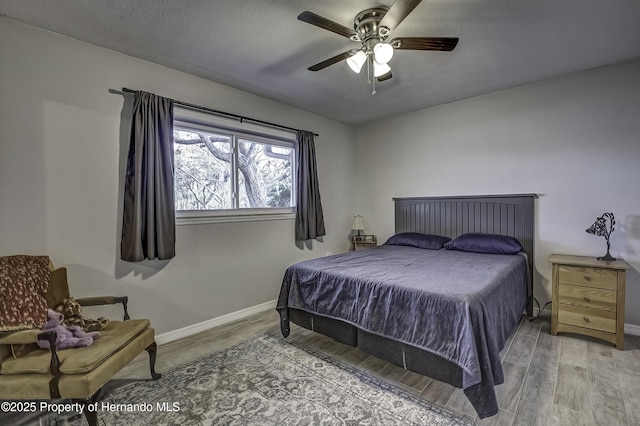 bedroom featuring ceiling fan and wood-type flooring