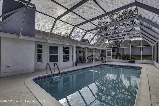 view of pool with a lanai and a patio area