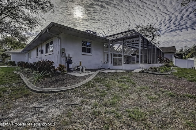 back of property featuring glass enclosure