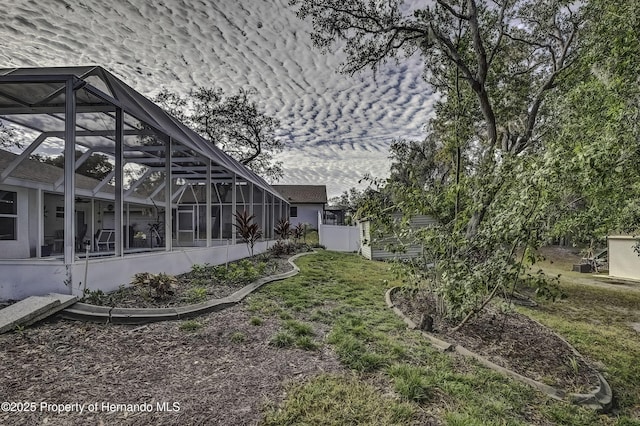 view of yard featuring glass enclosure