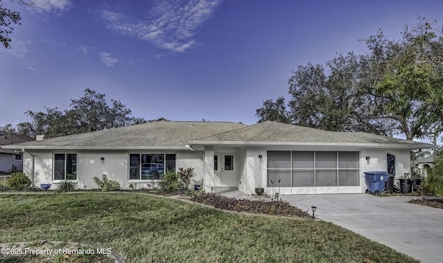 ranch-style home featuring a garage and a front yard