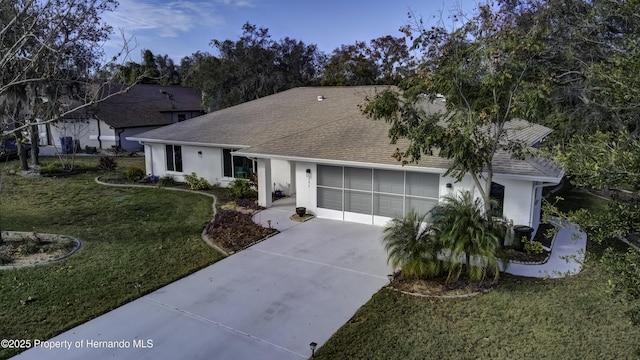 ranch-style house with a front yard and a garage