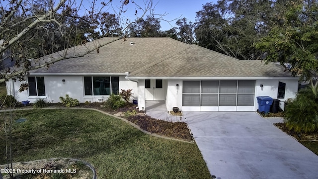 ranch-style home with a front yard and a garage