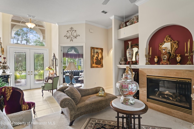 living room featuring ceiling fan, french doors, light tile patterned flooring, and a high ceiling