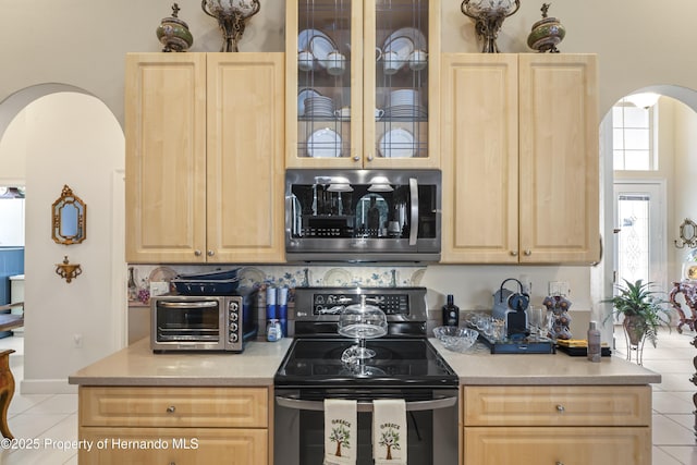 kitchen featuring range with electric cooktop and light brown cabinets