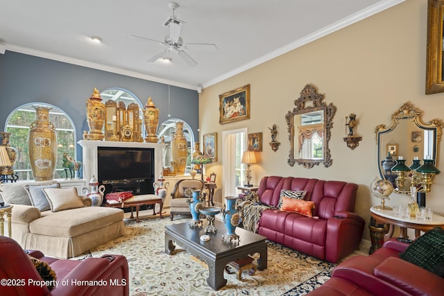 living room with ornamental molding and ceiling fan