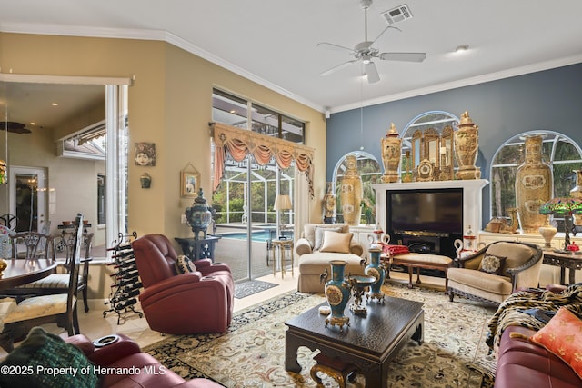 living room with ceiling fan and crown molding