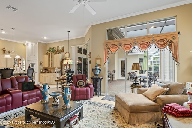 carpeted living room with ceiling fan and crown molding