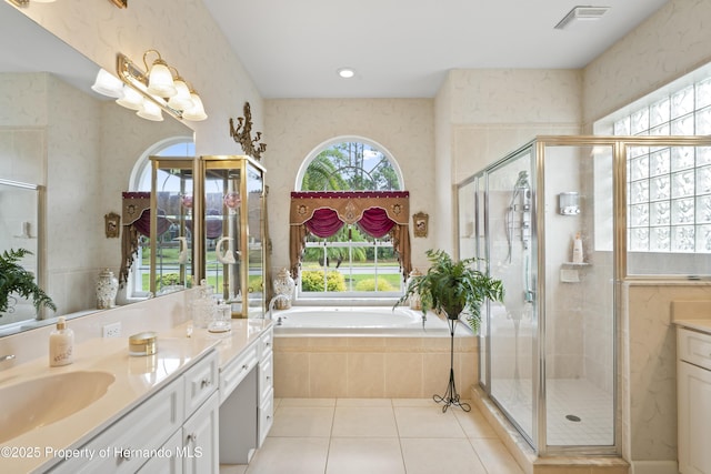 bathroom with tile patterned flooring, shower with separate bathtub, and vanity