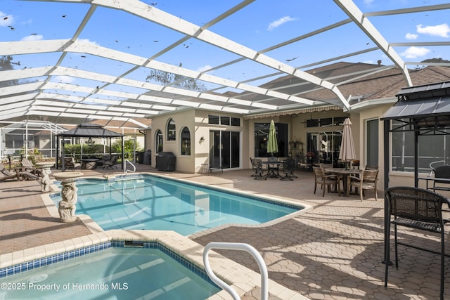 view of swimming pool featuring a lanai and a patio area