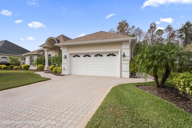 view of front of house with a front yard and a garage