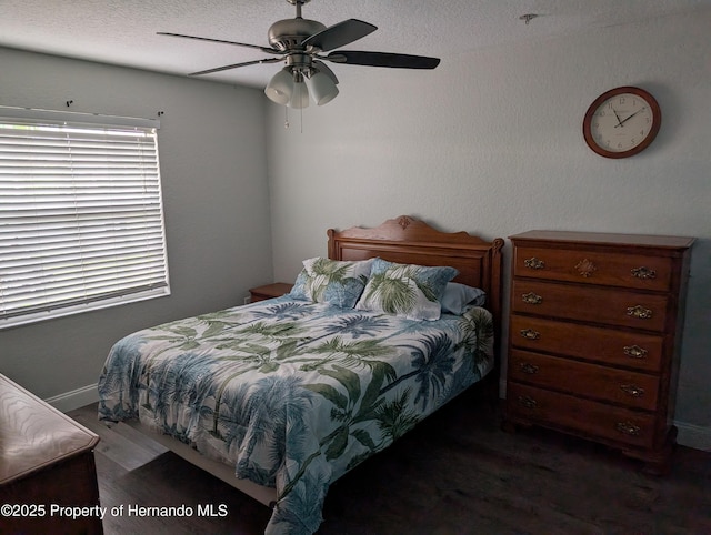 bedroom with ceiling fan and dark hardwood / wood-style flooring