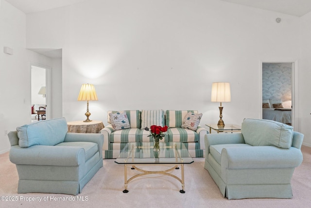 carpeted living room featuring lofted ceiling