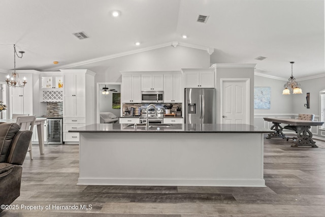 kitchen featuring tasteful backsplash, sink, stainless steel appliances, and white cabinetry