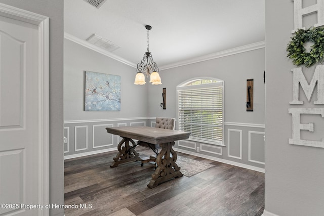 dining room featuring ornamental molding, a chandelier, and dark hardwood / wood-style flooring