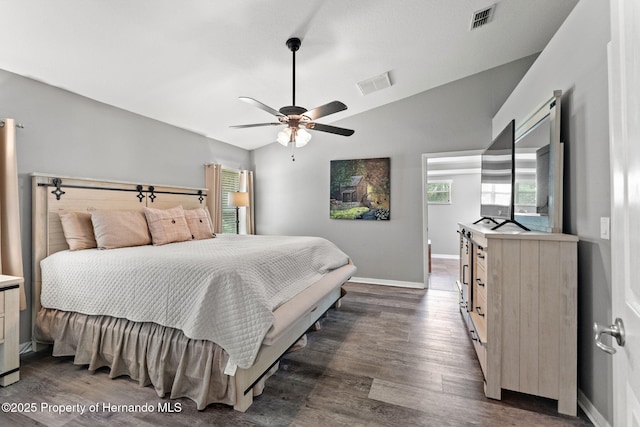 bedroom featuring ceiling fan, dark wood-type flooring, and lofted ceiling