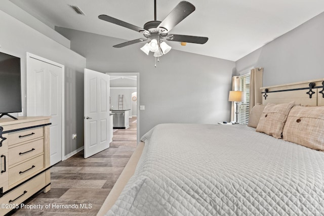 bedroom featuring vaulted ceiling, ceiling fan, and dark hardwood / wood-style floors