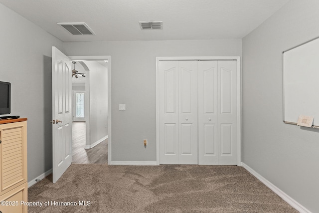 unfurnished bedroom with carpet and a closet