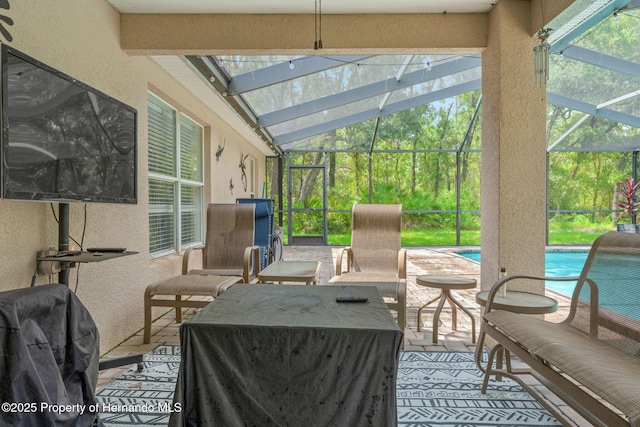 view of patio with glass enclosure