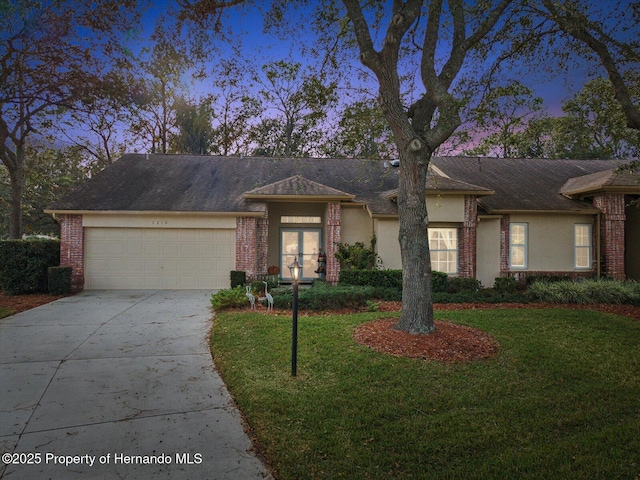 view of front of property featuring a garage and a yard