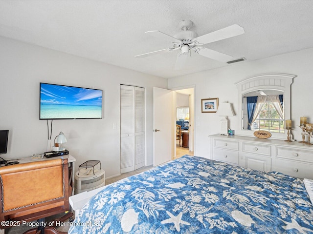 bedroom with a textured ceiling, a closet, and ceiling fan