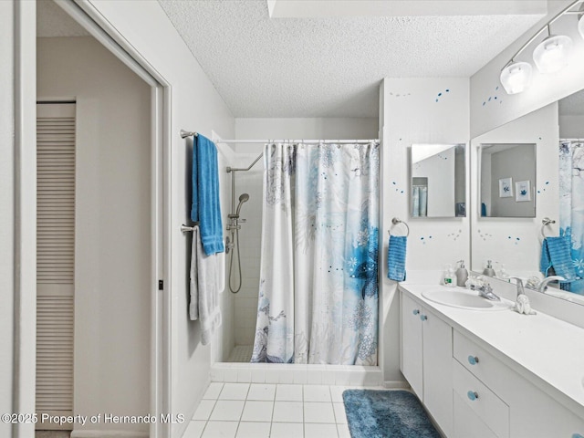 bathroom with vanity, curtained shower, tile patterned floors, and a textured ceiling