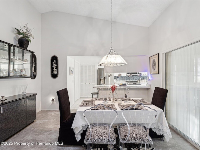 dining space featuring vaulted ceiling