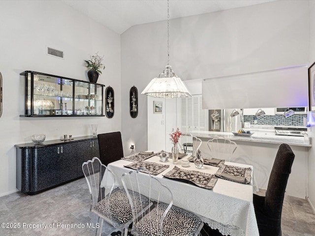 dining space featuring lofted ceiling