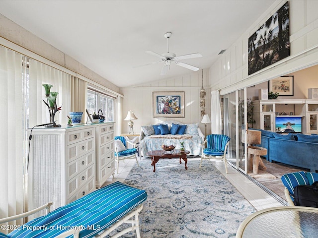 tiled living room with lofted ceiling and ceiling fan