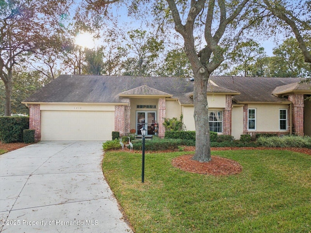 single story home with a garage, french doors, and a front lawn