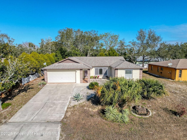 single story home with a front yard and a garage