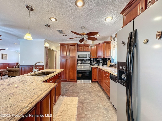 kitchen with decorative light fixtures, ceiling fan, appliances with stainless steel finishes, and sink