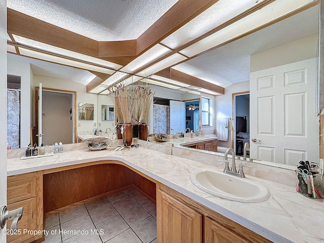 bathroom featuring vanity, tile patterned flooring, and a textured ceiling