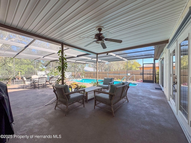 view of patio / terrace featuring an outdoor living space, glass enclosure, a fenced in pool, and ceiling fan