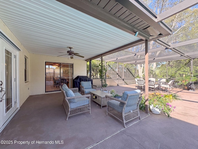 view of patio / terrace with ceiling fan, glass enclosure, and outdoor lounge area