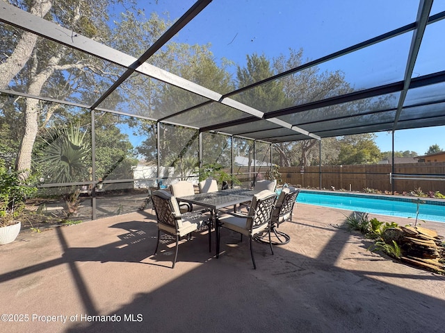 view of patio with a fenced in pool and glass enclosure