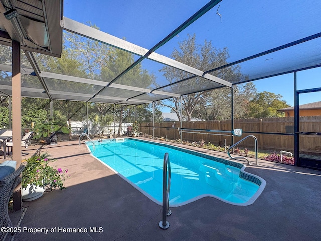 view of pool with a patio area and a lanai