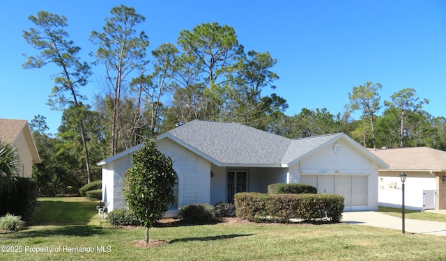 ranch-style home featuring a garage and a front yard