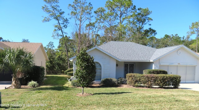 view of front facade with a garage and a front lawn