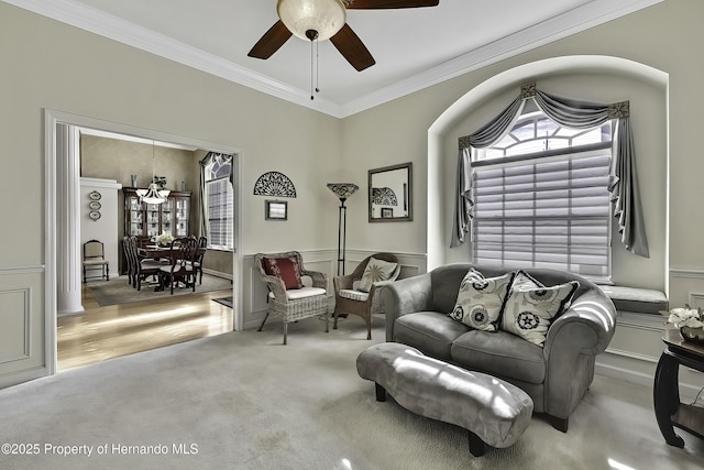 carpeted living room featuring ceiling fan and crown molding