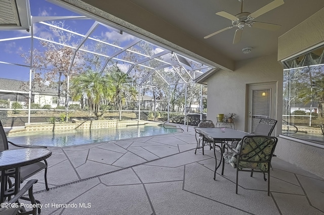 view of patio / terrace with a pool with hot tub, ceiling fan, and glass enclosure