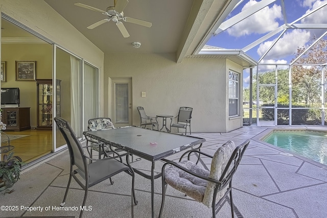 view of patio featuring glass enclosure and ceiling fan