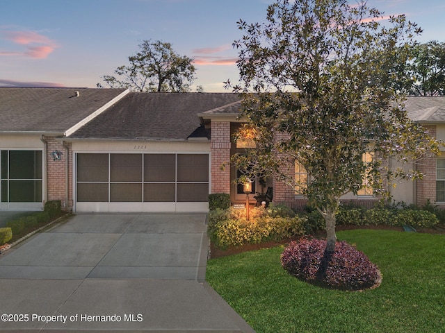 single story home with a yard and a garage