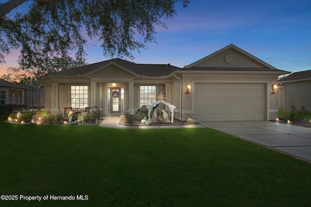 ranch-style house featuring a yard and a garage