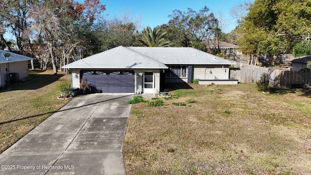 single story home featuring a garage and a front yard