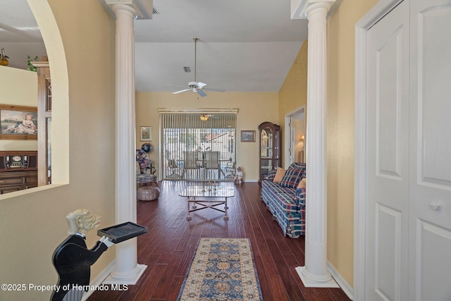 living room with lofted ceiling, dark hardwood / wood-style floors, ceiling fan, and ornate columns